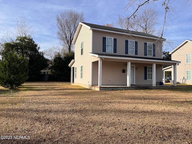 view of property featuring a front yard and a porch