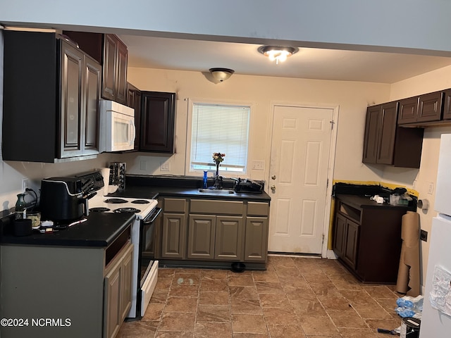 kitchen featuring sink, white appliances, and dark brown cabinets