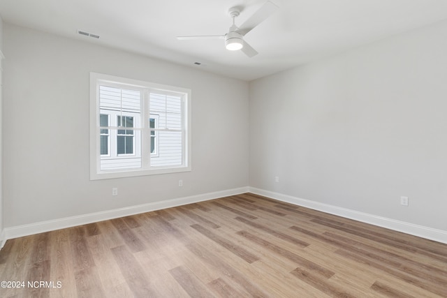 spare room with light hardwood / wood-style flooring and ceiling fan