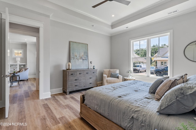 bedroom featuring crown molding, ceiling fan, and light wood-type flooring