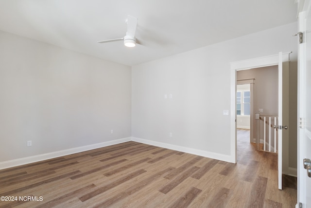 spare room featuring light wood-type flooring and ceiling fan