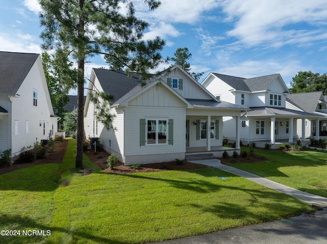 view of front facade with a front yard and a porch