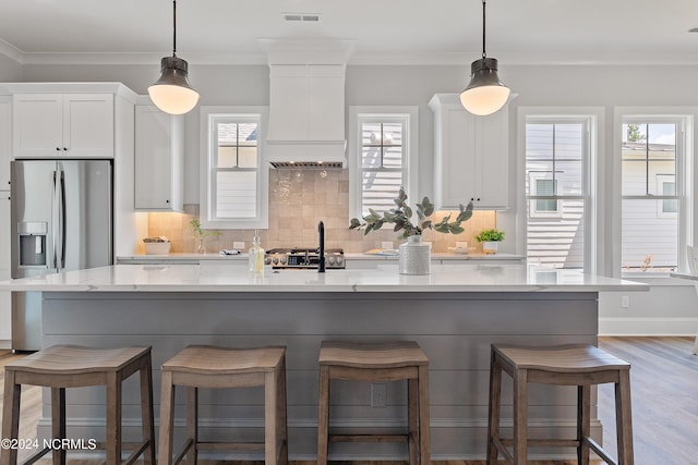 kitchen with light hardwood / wood-style flooring and a breakfast bar