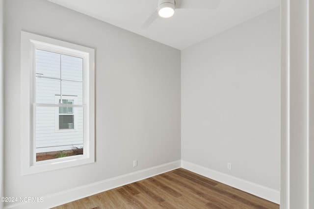 empty room with hardwood / wood-style flooring and ceiling fan