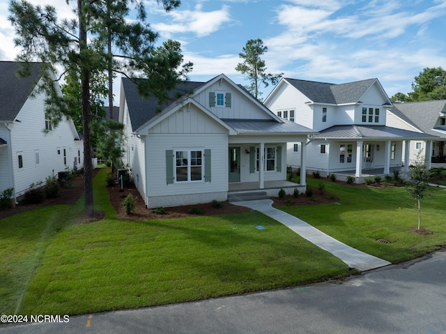 view of front of house with a front yard and a porch