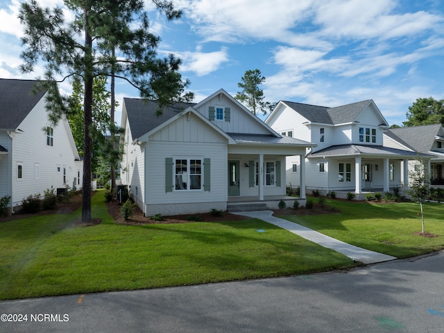 view of front of house with a front yard and a porch