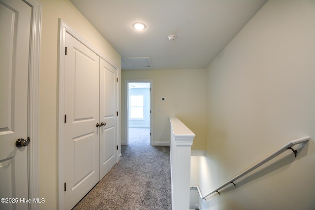 corridor with dark colored carpet