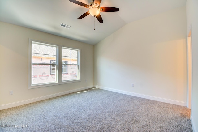 carpeted spare room with ceiling fan and lofted ceiling