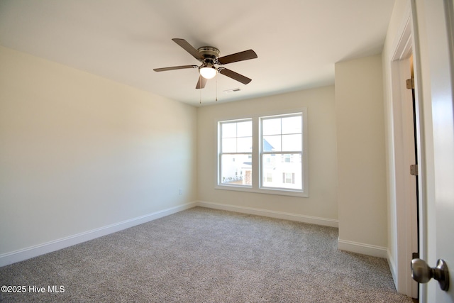 spare room featuring light carpet and ceiling fan