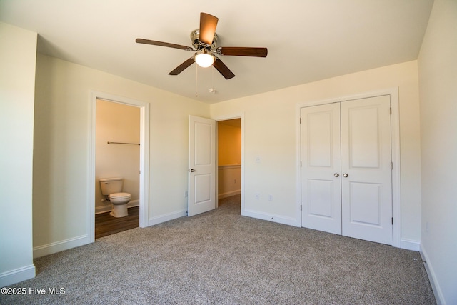 unfurnished bedroom with ensuite bathroom, carpet flooring, ceiling fan, and a closet