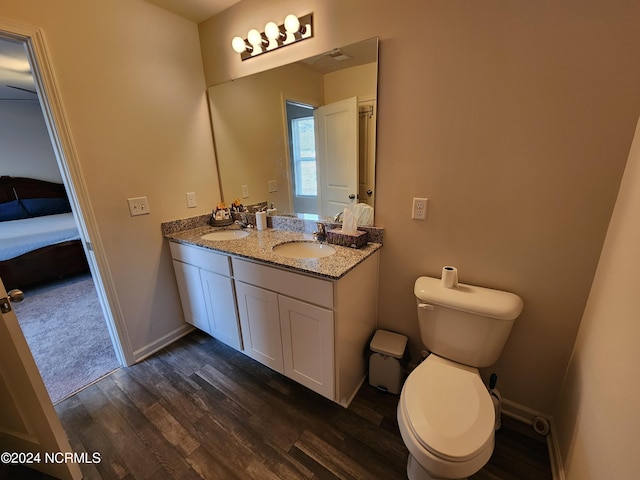 bathroom featuring hardwood / wood-style floors, vanity, and toilet