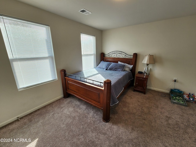 bedroom featuring dark carpet