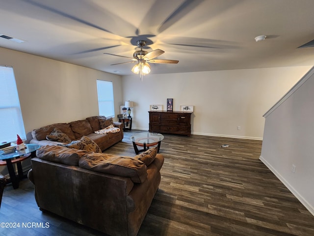 living room with ceiling fan and dark wood-type flooring