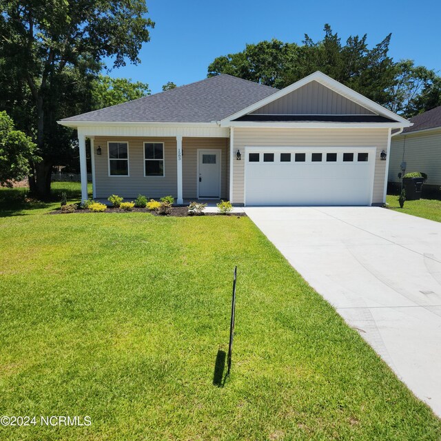 ranch-style house featuring a garage and a front yard