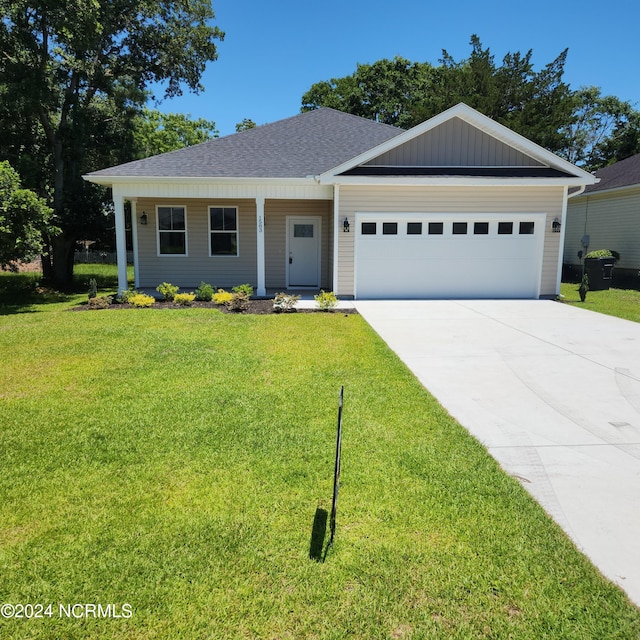 ranch-style house featuring a garage and a front yard