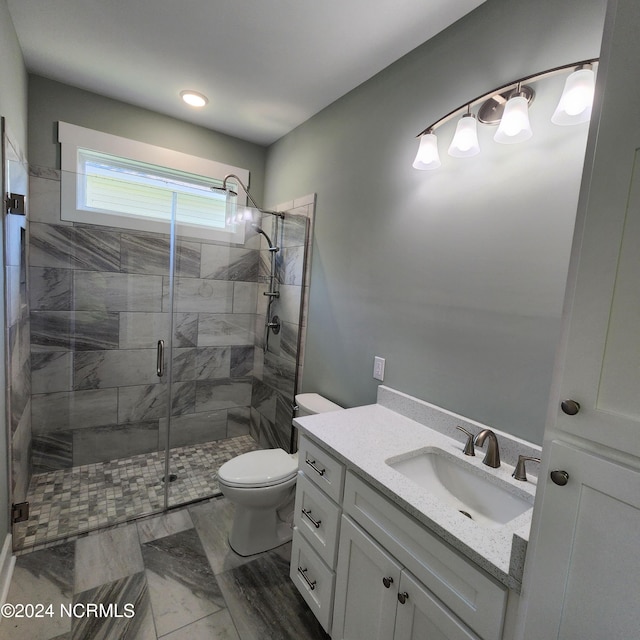 bathroom featuring vanity, toilet, and walk in shower