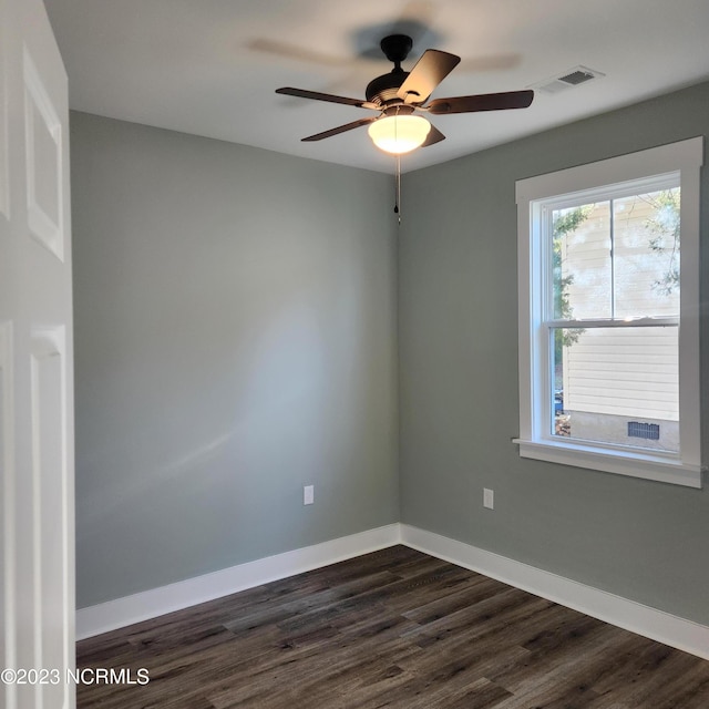 spare room with dark hardwood / wood-style floors and ceiling fan