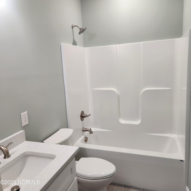 full bathroom with  shower combination, vanity, and toilet