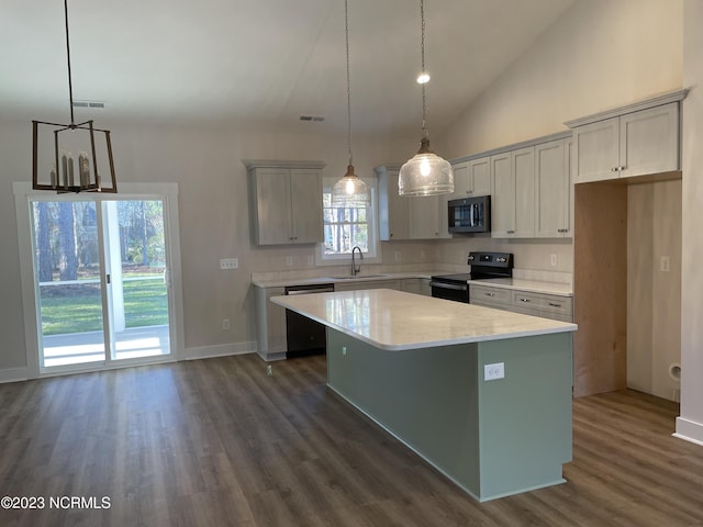 kitchen featuring a center island, black electric range oven, visible vents, a sink, and dishwasher