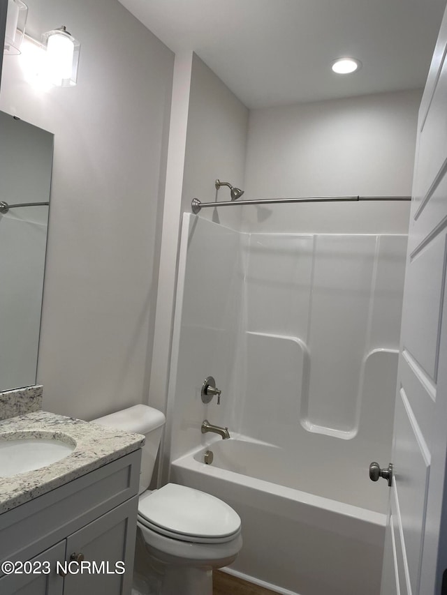 full bathroom with bathtub / shower combination, toilet, and vanity