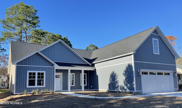 modern farmhouse featuring a porch and roof with shingles