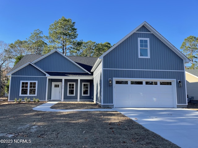 view of front of home featuring a shingled roof and board and batten siding