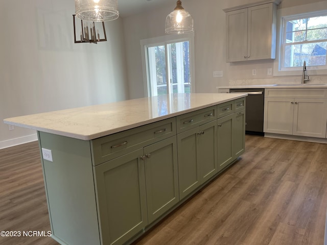 kitchen featuring a kitchen island, a sink, dishwasher, dark wood finished floors, and green cabinetry