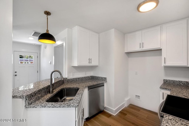 kitchen featuring white cabinets, pendant lighting, dishwasher, and wood-type flooring