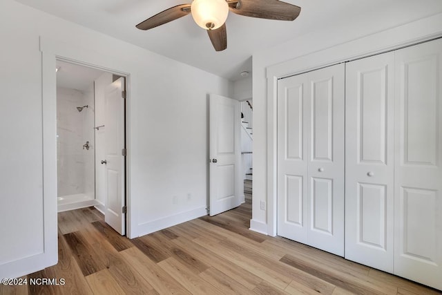 unfurnished bedroom with a closet, ceiling fan, ensuite bathroom, and light hardwood / wood-style flooring