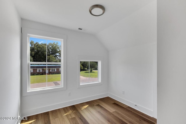 bonus room with lofted ceiling and wood-type flooring