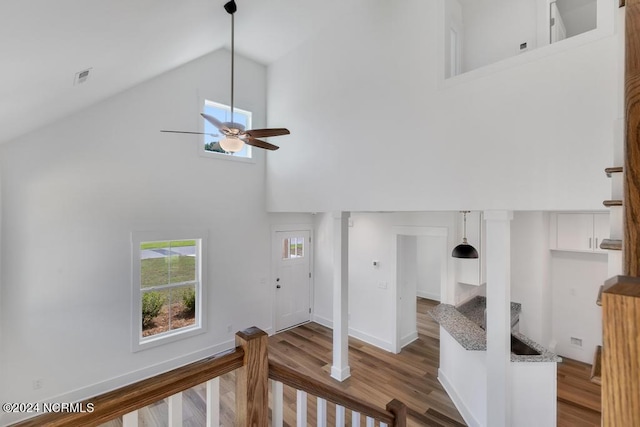 interior space featuring hardwood / wood-style flooring, high vaulted ceiling, and ceiling fan