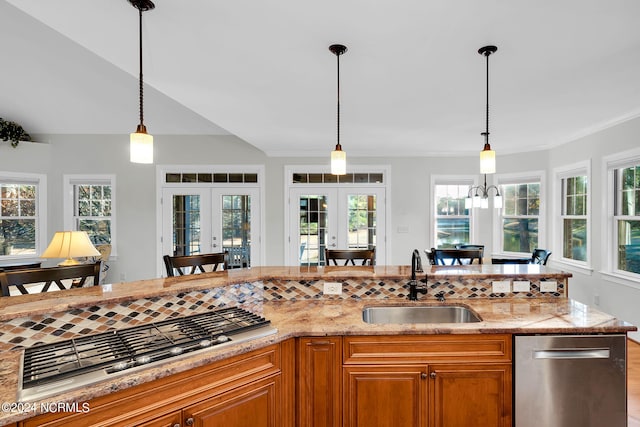 kitchen with appliances with stainless steel finishes, sink, and pendant lighting