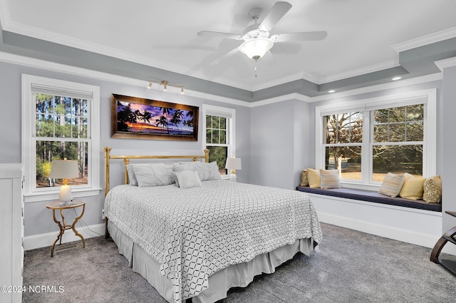 carpeted bedroom with ornamental molding, multiple windows, and ceiling fan