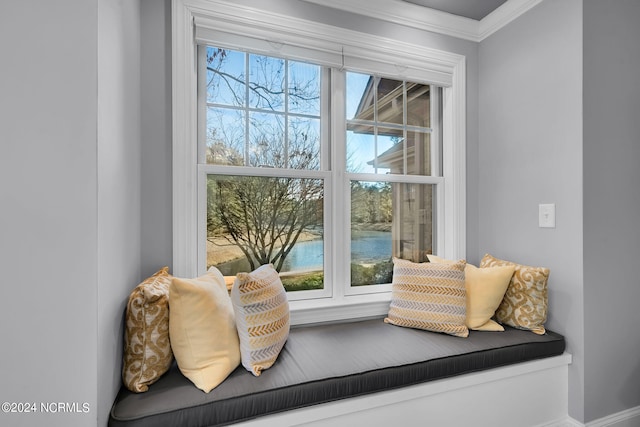 sitting room with ornamental molding and a water view