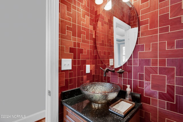 bathroom featuring tile walls and vanity