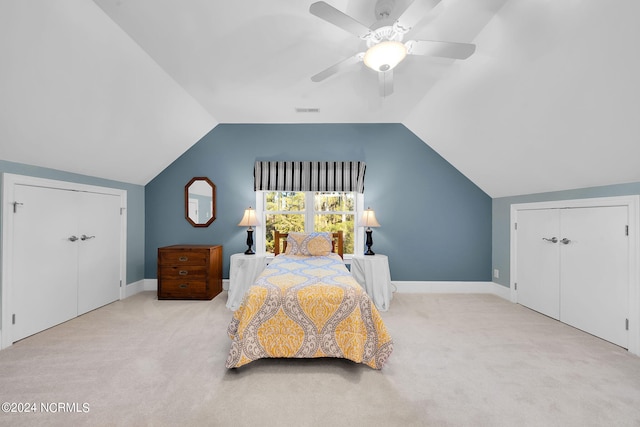 bedroom featuring a closet, light carpet, ceiling fan, and vaulted ceiling