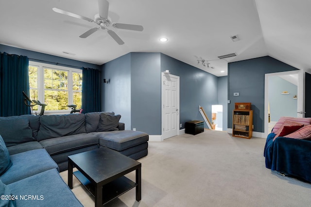 carpeted living room with rail lighting, ceiling fan, and lofted ceiling