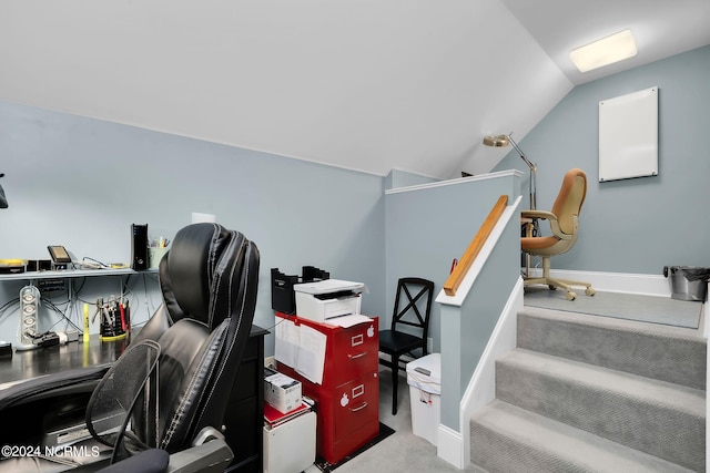 carpeted home office featuring lofted ceiling