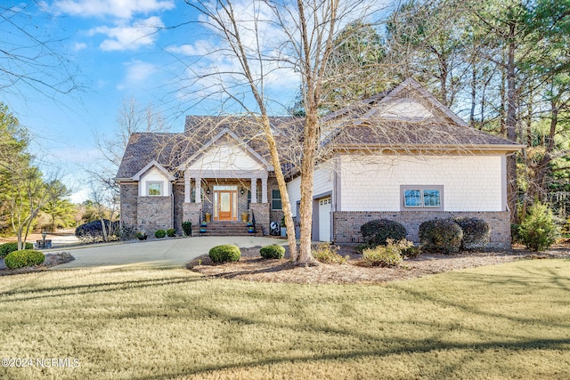 view of front of property with a garage and a front yard