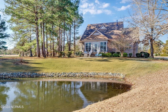 exterior space featuring a yard and a water view