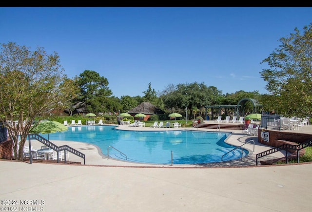 view of swimming pool featuring a patio area