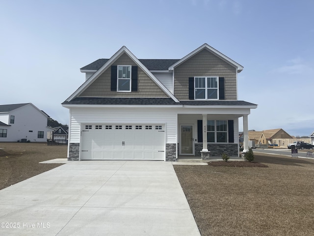 craftsman inspired home featuring covered porch, a shingled roof, concrete driveway, a garage, and stone siding