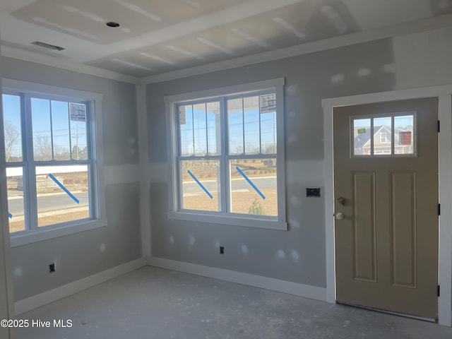 entrance foyer with plenty of natural light and concrete flooring