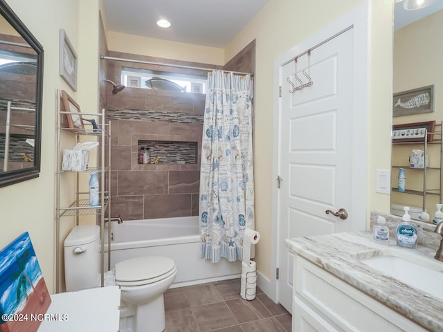 full bath featuring baseboards, toilet, shower / tub combo with curtain, tile patterned flooring, and vanity