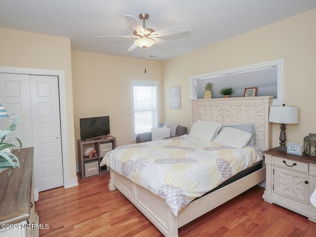 bedroom with ceiling fan and light wood-style flooring