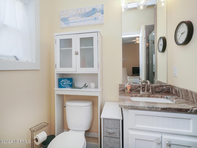 full bathroom with vanity, toilet, and a shower with door