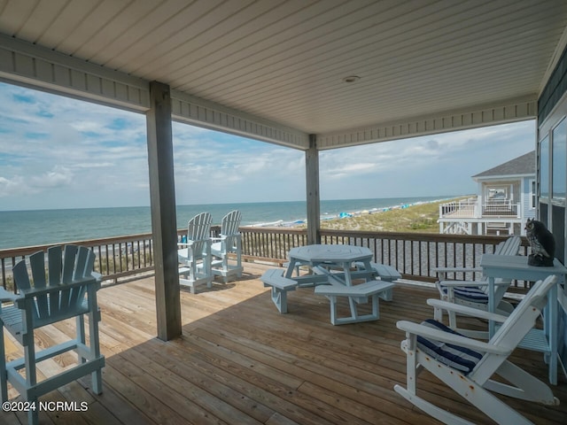 wooden terrace with a water view and a beach view