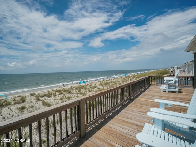 deck with a water view and a beach view