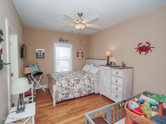 bedroom with light wood finished floors and ceiling fan