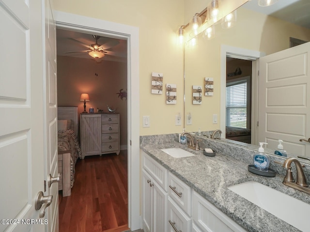 full bathroom featuring wood finished floors, ensuite bath, and a sink